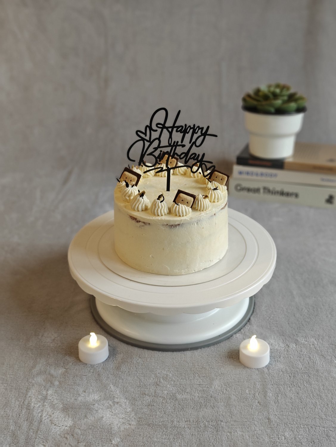 Cream cake with golden Biscoff cookies and pearl bead piping
